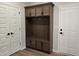 Mudroom featuring a built-in bench and storage with dark hardware and doors at 55 New Liberty Dr, Youngsville, NC 27596