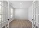 A well-lit home office space featuring hardwood floors and French doors at 55 New Liberty Dr, Youngsville, NC 27596