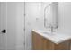 Bright bathroom with white countertops, modern mirror and sleek wood cabinets at 6701 Green Hollow Ct, Wake Forest, NC 27587