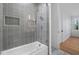 Modern bathroom featuring a shower over tub with gray tiled walls and glass screen at 6701 Green Hollow Ct, Wake Forest, NC 27587
