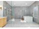 Sleek bathroom featuring a modern soaking tub, glass shower with golden hardware, and custom vanity at 6701 Green Hollow Ct, Wake Forest, NC 27587