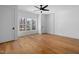 Spacious bedroom with hardwood floors, natural light, and a modern ceiling fan at 6701 Green Hollow Ct, Wake Forest, NC 27587