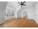 Bright bedroom featuring hardwood floors, large windows, and a modern ceiling fan at 6701 Green Hollow Ct, Wake Forest, NC 27587