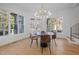 Bright dining area with wood floors, contemporary lighting fixture, and a walkout to the rear porch at 6701 Green Hollow Ct, Wake Forest, NC 27587