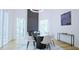 Bright dining room with large windows, sleek black table and modern fireplace at 6701 Green Hollow Ct, Wake Forest, NC 27587