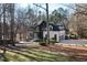 Modern farmhouse exterior with a three-car garage and large front yard at 6701 Green Hollow Ct, Wake Forest, NC 27587