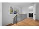 Hallway with hardwood floors, iron railings and a view of the laundry room at 6701 Green Hollow Ct, Wake Forest, NC 27587