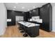 Spacious kitchen features a center island with bar seating and dark cabinetry at 6701 Green Hollow Ct, Wake Forest, NC 27587