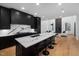 Open kitchen layout with island seating and a view into the modern living room at 6701 Green Hollow Ct, Wake Forest, NC 27587
