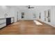 Open living room with hardwood floors and a wet bar with white countertop at 6701 Green Hollow Ct, Wake Forest, NC 27587