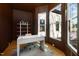 Well-lit home office with modern desk, ample shelving and large windows at 6701 Green Hollow Ct, Wake Forest, NC 27587