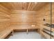 Relaxing home sauna featuring wood paneling, benches, and glass door at 6701 Green Hollow Ct, Wake Forest, NC 27587