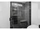 Modern shower featuring black tile, glass door, and a rainfall showerhead at 6701 Green Hollow Ct, Wake Forest, NC 27587