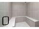 Modern shower with gray tile and corner bench seating at 6701 Green Hollow Ct, Wake Forest, NC 27587