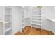 Spacious walk-in closet with white shelving and hardwood floors at 6701 Green Hollow Ct, Wake Forest, NC 27587