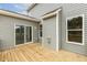 Back porch with sliding doors, window and outdoor light with wood decking at 85 Kissington Way, Benson, NC 27504