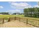 View from wooden deck of two-story home overlooking large grassy backyard at 85 Kissington Way, Benson, NC 27504