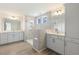 Elegant bathroom features double vanity, glass shower, gray cabinets, and modern fixtures for a luxurious experience at 85 Kissington Way, Benson, NC 27504