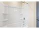 Bright bathroom features a sleek tub with shower and built-in shelving for storage at 85 Kissington Way, Benson, NC 27504