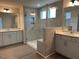 Modern bathroom featuring a glass-enclosed shower and dual vanities at 85 Kissington Way, Benson, NC 27504