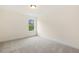 An empty bedroom with neutral walls, plush carpet, and a window with natural light at 85 Kissington Way, Benson, NC 27504