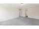 Neutral bedroom with gray carpet; open doorway leads to other parts of home, enhancing its spacious feel at 85 Kissington Way, Benson, NC 27504