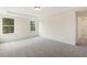 Bright bedroom boasts neutral walls, soft gray carpet, and great natural light from two generous windows at 85 Kissington Way, Benson, NC 27504