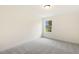 Cozy bedroom features neutral walls, soft gray carpet, and a window bringing in natural light and outdoor view at 85 Kissington Way, Benson, NC 27504