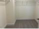 Walk-in closet featuring carpet floor and ample shelving space at 85 Kissington Way, Benson, NC 27504