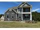 Beautiful two-story home featuring stone accents, a covered porch, and manicured landscaping at 85 Kissington Way, Benson, NC 27504