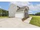 Two-story home with stone accents, side-entry garage, and manicured lawn at 85 Kissington Way, Benson, NC 27504