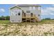 Exterior shot of home with porch, blue siding, green lawn, and blue sky at 85 Kissington Way, Benson, NC 27504