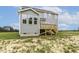 Exterior shot of home with porch, blue siding, green lawn, and blue sky at 85 Kissington Way, Benson, NC 27504