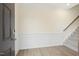 Bright foyer with elegant wainscoting, wood floors, and staircase leading to the second level at 85 Kissington Way, Benson, NC 27504