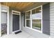 Inviting front entrance featuring a large window, modern door, and stylish wood ceiling on the porch at 85 Kissington Way, Benson, NC 27504