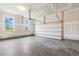 Spacious two-car garage with ample room and natural light streaming through the windows at 85 Kissington Way, Benson, NC 27504