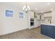 Bright eat-in kitchen area with white cabinets, stainless appliances, and a stylish chandelier at 85 Kissington Way, Benson, NC 27504