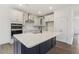 Kitchen features a large island, modern appliances and a stylish backsplash at 85 Kissington Way, Benson, NC 27504