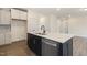 Modern kitchen island featuring a stainless steel sink and a stone countertop at 85 Kissington Way, Benson, NC 27504