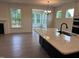 Open kitchen featuring an island with a granite countertop and views to the living room at 85 Kissington Way, Benson, NC 27504