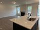 Inviting eat-in kitchen with stone counter tops, black appliances and plenty of natural light at 85 Kissington Way, Benson, NC 27504