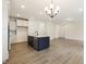 Open living space showcasing hardwood floors and a kitchen island with pendant lighting at 85 Kissington Way, Benson, NC 27504