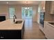 Kitchen area featuring an island with granite countertops, stainless appliances, and open floorplan at 85 Kissington Way, Benson, NC 27504