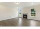 Elegant living room with hardwood floors, fireplace, and abundant natural light from large windows at 85 Kissington Way, Benson, NC 27504