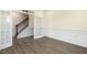Spacious living room featuring modern wood floors, decorative wainscoting, and ample natural light at 85 Kissington Way, Benson, NC 27504