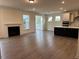 Spacious living area featuring a cozy fireplace and an open kitchen layout at 85 Kissington Way, Benson, NC 27504