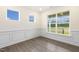 Bright, airy living room with large windows offering scenic views and stylish wainscoting at 85 Kissington Way, Benson, NC 27504