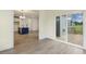 Open living area leading to a modern kitchen and outdoor deck through sliding glass doors at 85 Kissington Way, Benson, NC 27504