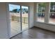 Bright living room showing sliding glass doors to a deck and large windows offering natural light at 85 Kissington Way, Benson, NC 27504