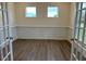 Home office featuring wainscoting, two windows, and glass French doors at 85 Kissington Way, Benson, NC 27504